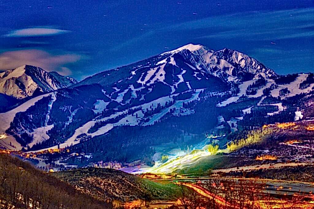 Aspen village and mountains with lights at night
